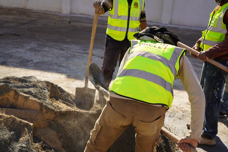 Volunteers mixing sand and cement