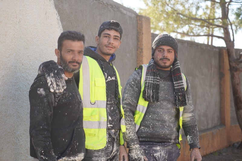 Uncle T workers at a restored school
